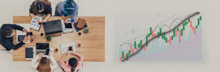 A diverse business team engaged in a strategy meeting, analyzing financial graphs and data. The scene captures collaboration and productivity in a modern workspace. Impute