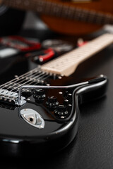 Fototapeta premium Electric guitar adjustment with focus on the bridge and tuning stability. Electric guitar setup with repair tools. Electric guitar bridge adjustment with tremolo installation and setup tools nearby.