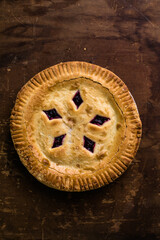 Rustic cherry pie with milk on wooden background, homemade dessert style