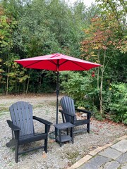 Obraz premium deck chairs and umbrella in garden