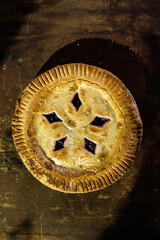 Rustic cherry pie with milk on wooden background, homemade dessert style