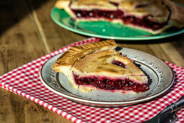 Rustic cherry pie with milk on wooden background, homemade dessert style
