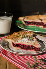Rustic cherry pie with milk on wooden background, homemade dessert style