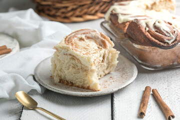 Cinnamon rolls with icing on white wooden boards, sweet homemade pastry