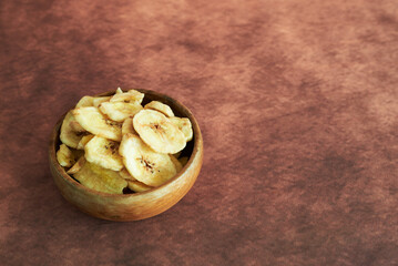 Dried banana chips in bowl healthy snack