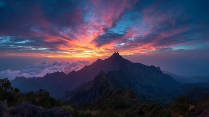 Breathtaking mountain vista at sunrise with vibrant, dramatic clouds painting the sky