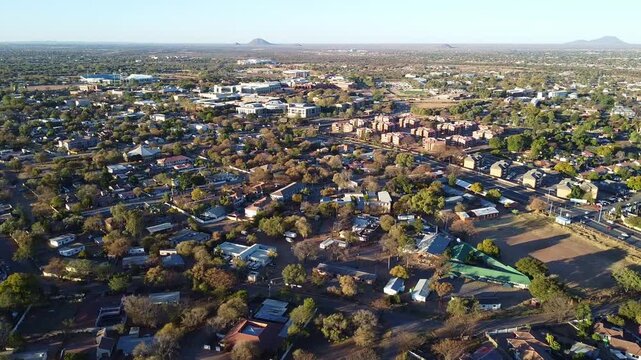 Aerial view of a residential area with houses, trees, and streets in botswana