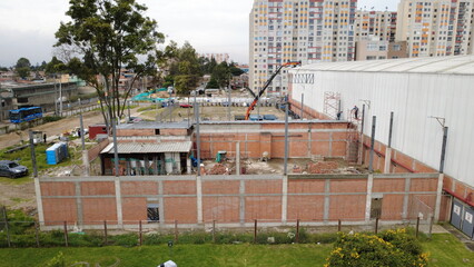 construction worker climbing scaffolding inside building under construction