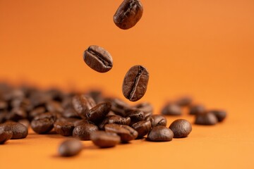 Fototapeta premium Freshly roasted coffee beans falling with motion blur onto a pile on an vibrant orange background, highlighting energy