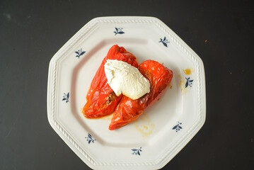 Stuffed red pointed peppers baked with meat inside and sweet cream ready to eat