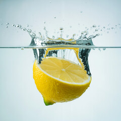 Fresh lemon slice and water splash in a glass of cold drink