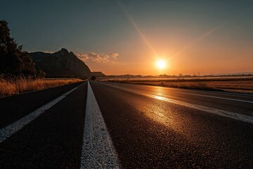 Fototapeta premium Sunrise over a paved road