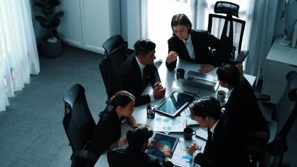 Top view businesspeople placed tablet at table and planning strategy while diverse team discuss about financial plan. Group of diverse team brainstorm marketing idea at meeting table. Directorate. - Powered by Adobe