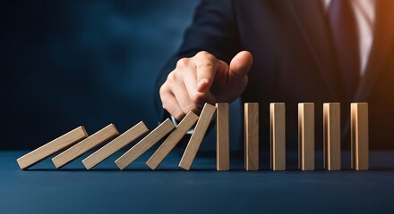 Business leader stopping domino effect of falling blocks
