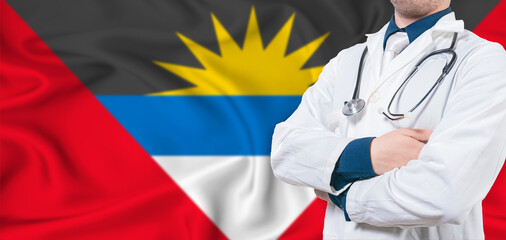 Antigua and Barbuda healthcare concept. Male doctor on Antigua and Barbuda flag. Doctor with...