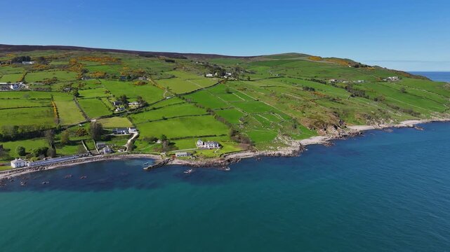 Aerial Drone View of Cushendun Bay on the Irish Sea County Antrim Northern Ireland on a sunny day with a blue sky 