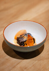 Chocolate Brownie Dessert with Ice Cream and Candied Orange