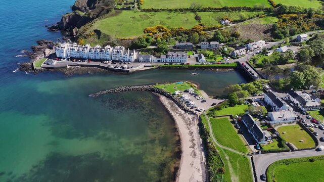 Aerial Drone shot of Cushendun village Glendun on the Irish Sea County Antrim Northern Ireland on a sunny day with a blue sky 