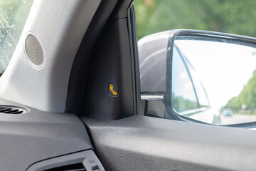 Vehicle safety system showing blind spot warning near mirror