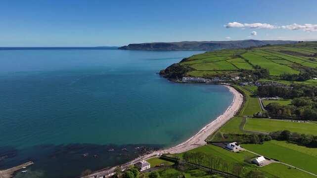 Aerial Drone View of Cushendun Bay on the Irish Sea County Antrim Northern Ireland on a sunny day with a blue sky 