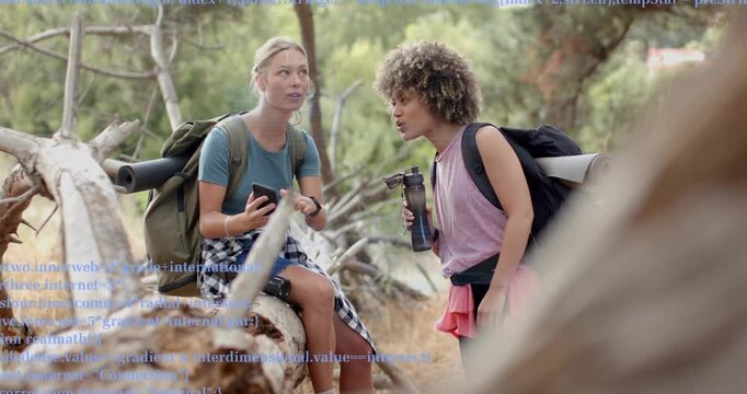 Two hikers on trail scrolling smartphone and examining blue technology code overlay seeking source