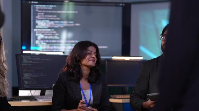 Intelligence analysts in a government command center receive a mission briefing, observing critical data on a large video wall before a surveillance or security operation.