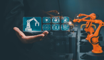Factory control concept, business professional using holographic tablet to manage robotic arms, overlaying lock, firewall icons to highlight data security, industrial automation, smart manufacturing.