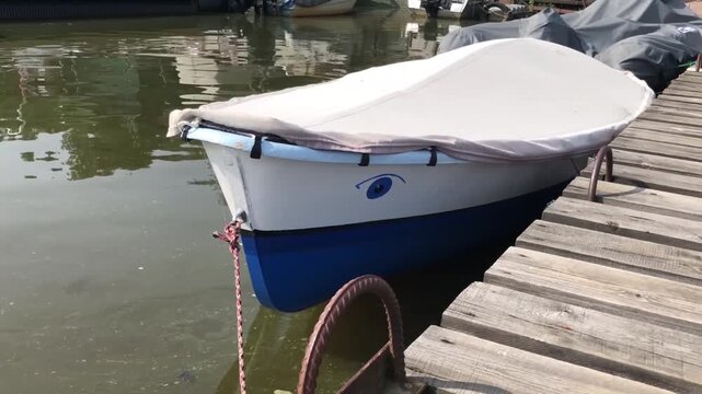 fishing boat moored at a wooden pier