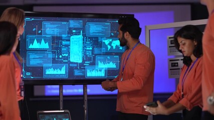 A data scientist presents a new business intelligence (BI) dashboard. He is explaining the key performance indicators (KPIs) and complex data visualizations to the project team. - Powered by Adobe