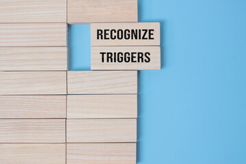 Recognize triggers symbol. Concept words Recognize triggers on wooden blocks. Beautiful grey green background. Business and Recognize triggers concept