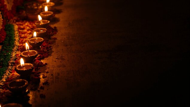 Beautiful Diwali celebration with glowing oil lamps and vibrant flower decorations creating a warm and festive atmosphere for cultural events and traditions