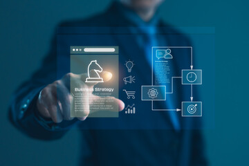 Businessman using virtual screen to present digital business strategy icons and planning workflow for performance and success development