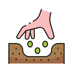 Hand dropping seeds into soil