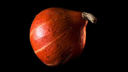 Pumpkins and other decorative items for Halloween and Day of the Dead festivities with red and...