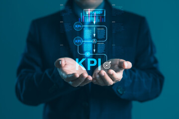 Businessman holding KPI digital interface with strategy chart and workflow icons for goal tracking and data-driven business performance improvement