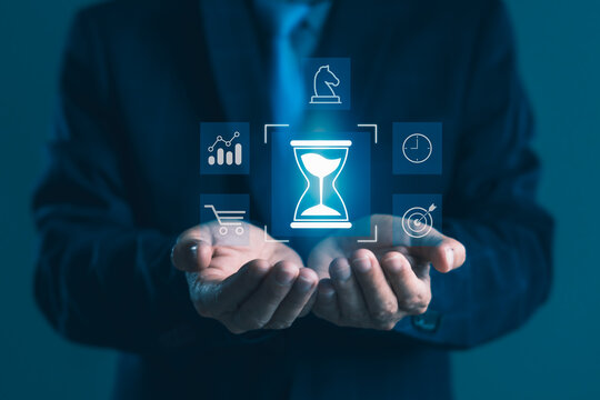 Businessman presenting digital hourglass with time, strategy, e-commerce, and analytics icons for efficient time management and business planning