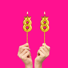 Birthday on a fuchsia background with the number 88 - Hands holding number-shaped candles