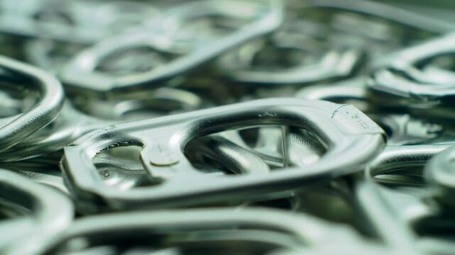 Close-up of many aluminum can pull tabs