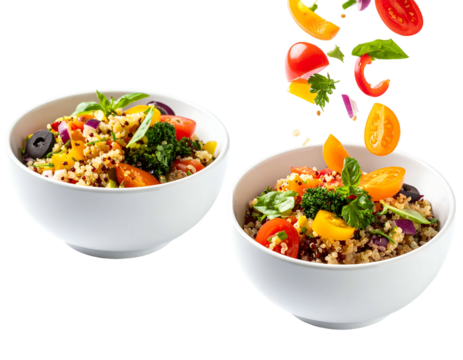 Two white bowls of quinoa salad with fresh vegetables falling in - Powered by Adobe