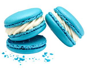 Three vibrant blue macarons, filled with white cream, on a white background with crumbs