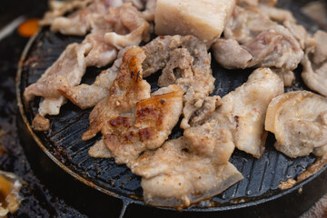 Close-up of Grilled Meat on a Sizzling Plate, Capturing Juicy Textures and Delicious Flavors for Culinary Enthusiasts and Food Photography