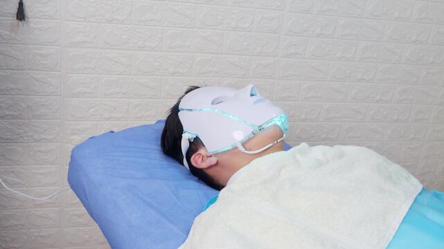 Man receiving led light therapy facial rejuvenation treatment