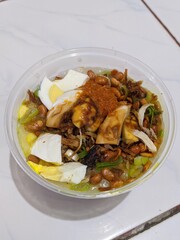 Indonesian Chicken Porridge with Egg, Peanuts, and Savory Toppings