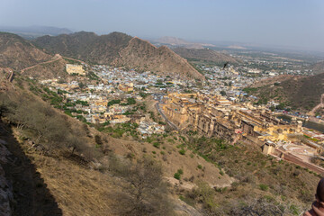 Obraz premium High-Angle View Down the Red Fortification Wall with Historical Town and Palace Below