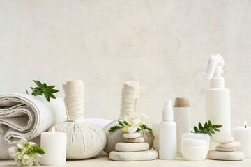 Composition with different cosmetic products, spa accessories, burning candles and flowers on light background