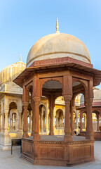 Ancient Stone Cenotaphs with Ornate Domes and Pillars at Sunset