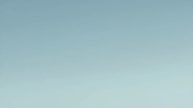 Soft white cloud heart shape floating gently across blue sky