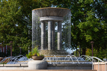 Cascading water fountain in downtown Cary park. Stunning fountain in downtown Cary, North Carolina, with cascading streams of water forming curtain around stone columns.