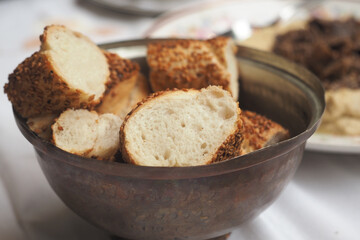 Freshly baked bread in a decorative bowl at a meal