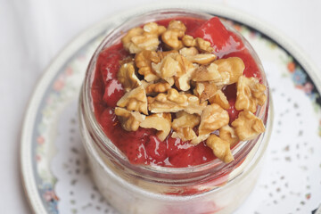 Dessert with strawberries and walnuts in a jar